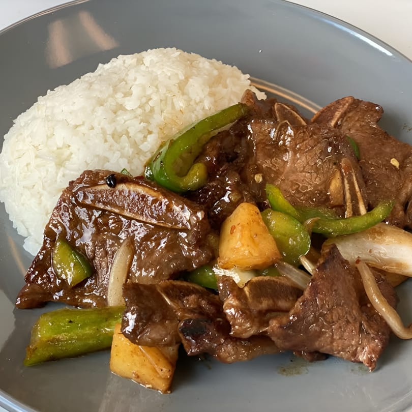 Golden Phoenix Chinese Restaurant's beef short ribs with green peppers, onions, and pineapple, served with rice.